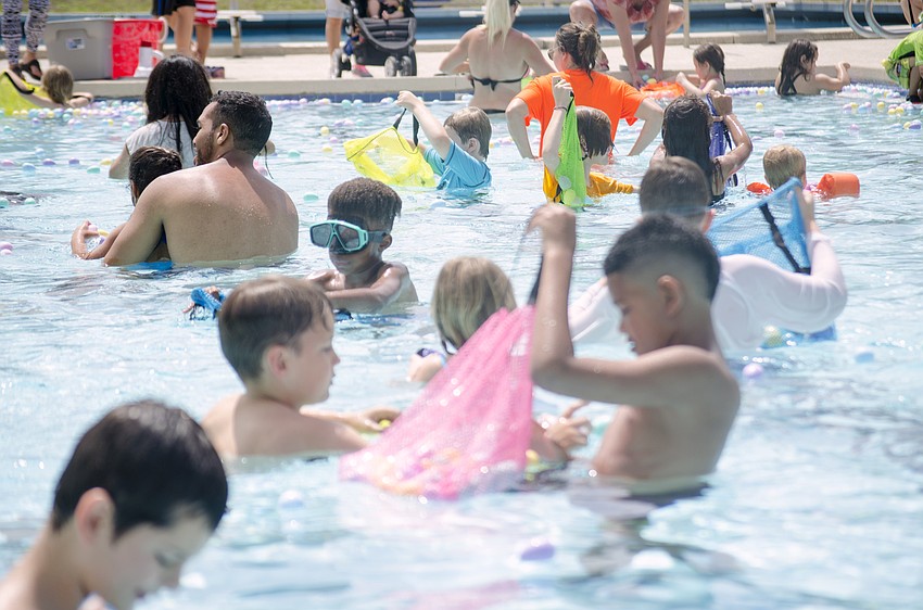 Sarasota families participate in one of the eight of the egg hunts put on during the Arlington Park Spring Splash.