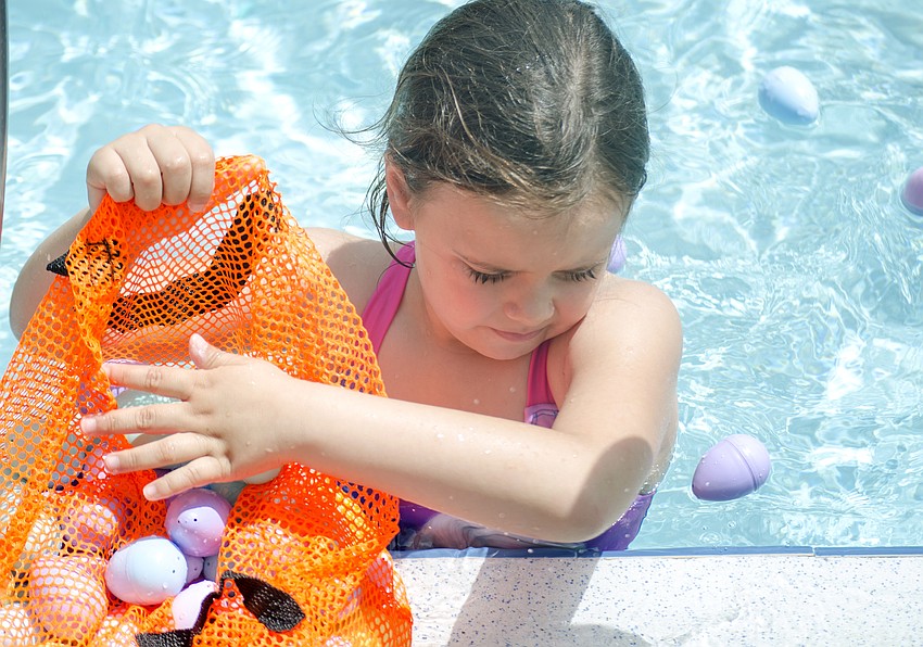 Ashleigh Canfield collects eggs during the Arlington Park Spring Splash.