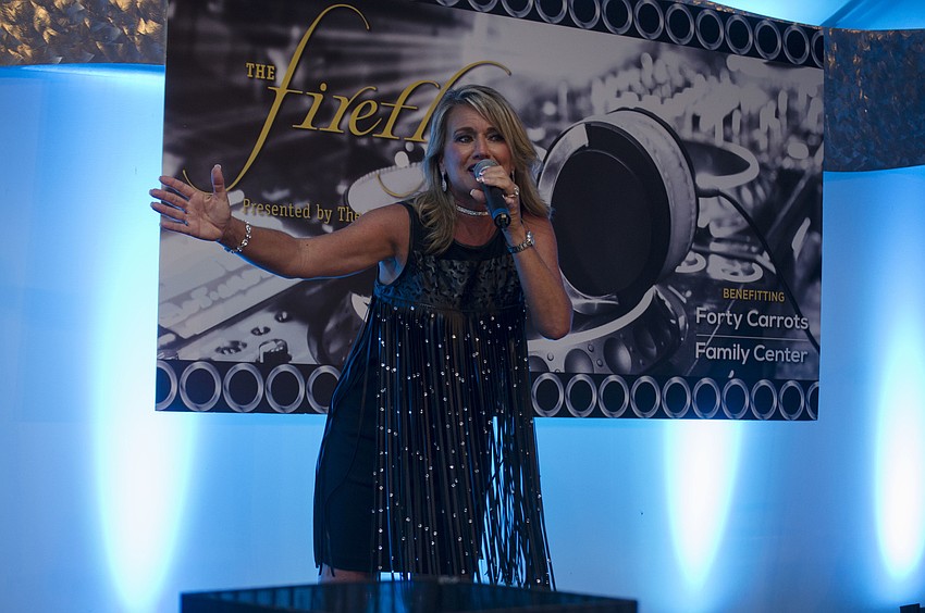 International Champion Auctioneer Wendy Lambert leads the live auction at Firefly Gala on April 1 at The Ritz-Carlton Members Golf Club.