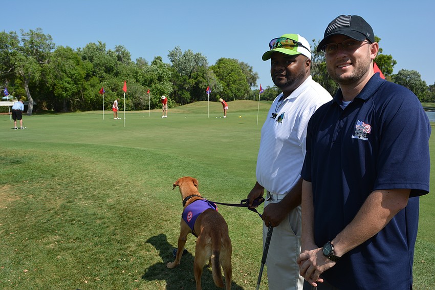 Staff Sgt. Christopher Gordon and Capt. Bobby Withers, who both represent the Homes for Our Troops program,  get ready for the tournament.