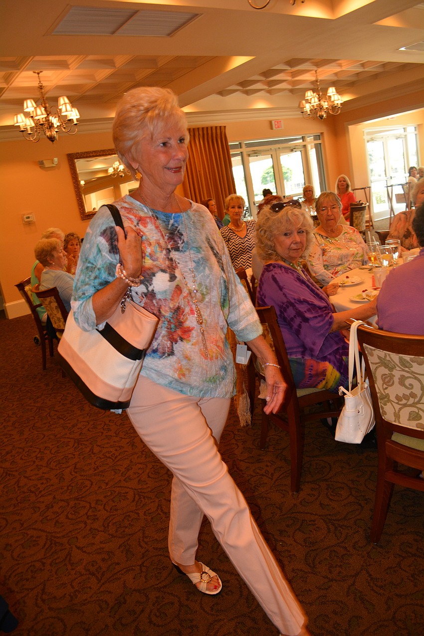 Mary Carol models a shirt by Jess & Jane and slacks by Zac & Rachel.
