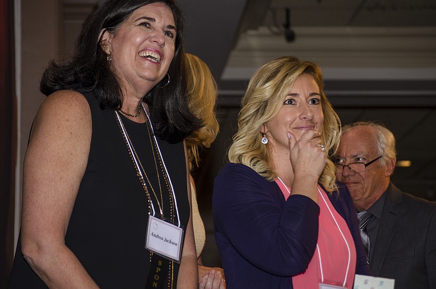 Andrea Jackson and Sarasota County Teacher of the Year finalist Holly Houghton-Brown react while watching a video of Brown'  s reaction to being named a Sarasota County Teacher of the Year finalist.
