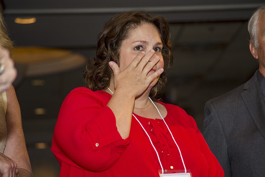 Christine Braun wipes a tear from her eye while being recognized as  a Sarasota County Teacher of the Year finalist.