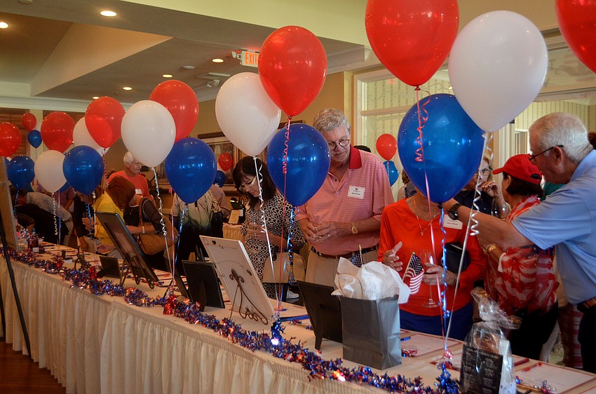 Guests mingle and peruse the the silent auction table during cocktail hour.