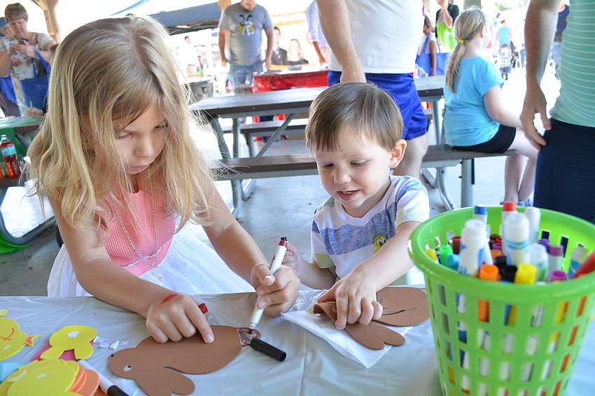Cousins Dakota Mikos and Adam Mikos, both of Sarasota, work on a craft before the hunt begins.