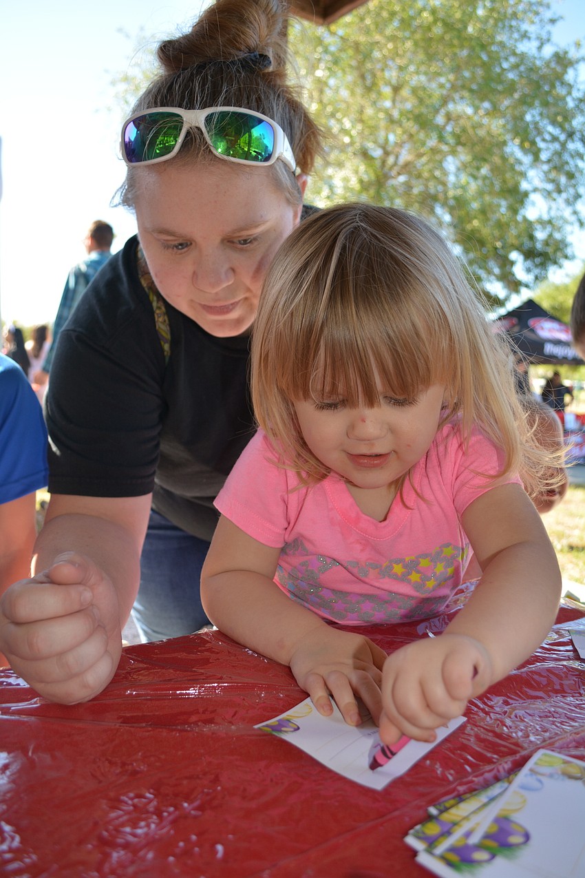 Brittany Jent, of Parrish, helps her daughter, Sophia, with a craft.