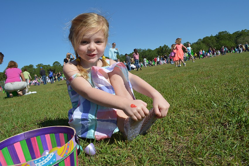 Peyton Colllins, of Lakewood Ranch, breaks her eggs apart in search of candy.