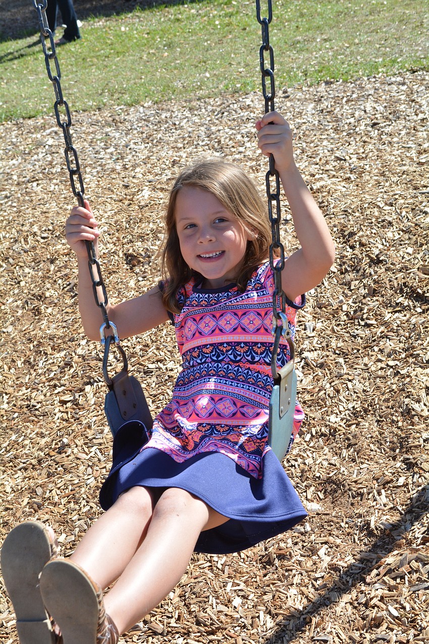 Molly James, of Greenbrook, swings alongside her twin sister, Addison, not pictured.