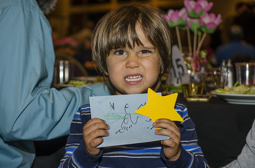 Everett Vaughan shows off a card he made for his teacher.