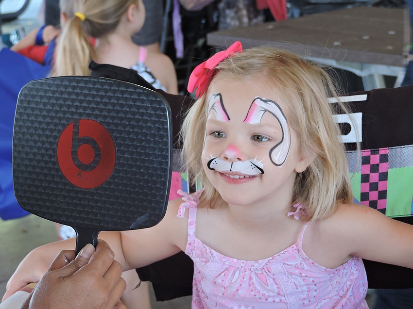 Lakewood Ranch' s Lauren Otterness, 4, checks out her face painting before searching for eggs.