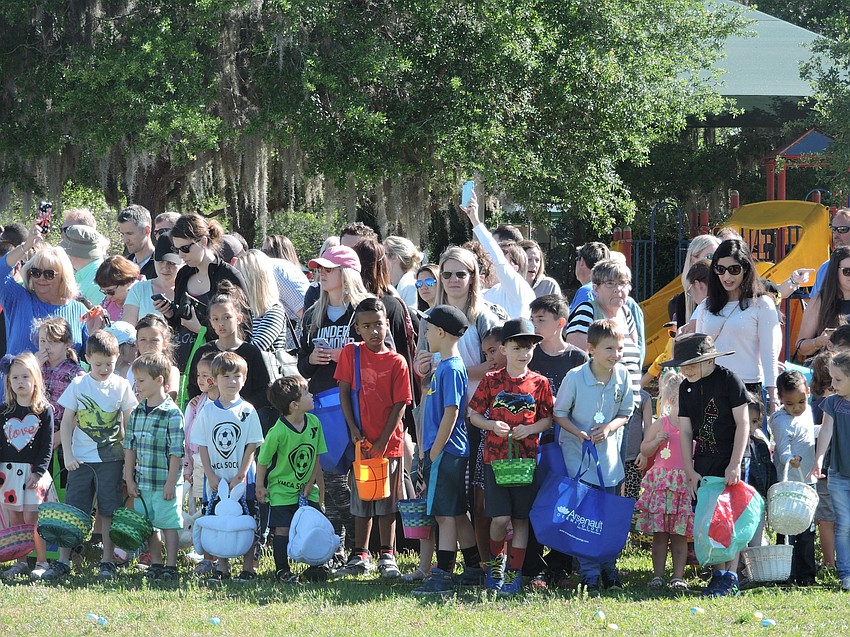 The children are at the ready as they are about to be released for the egg hunt.