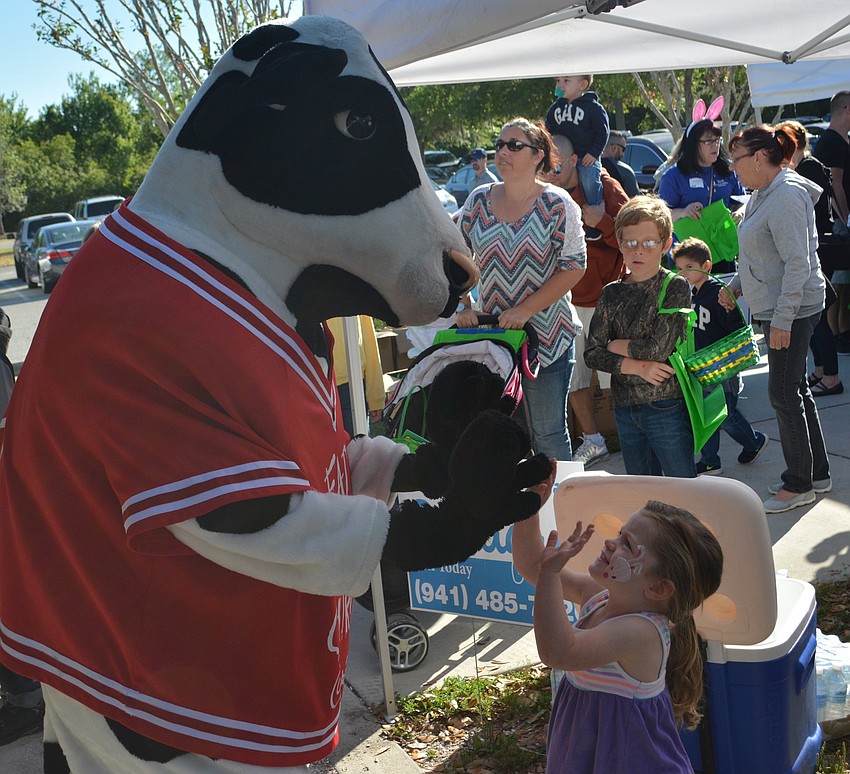 The Chick-fil-A cow gets high fives from Lakewood Ranch' s Kamryn Bewley, 2.