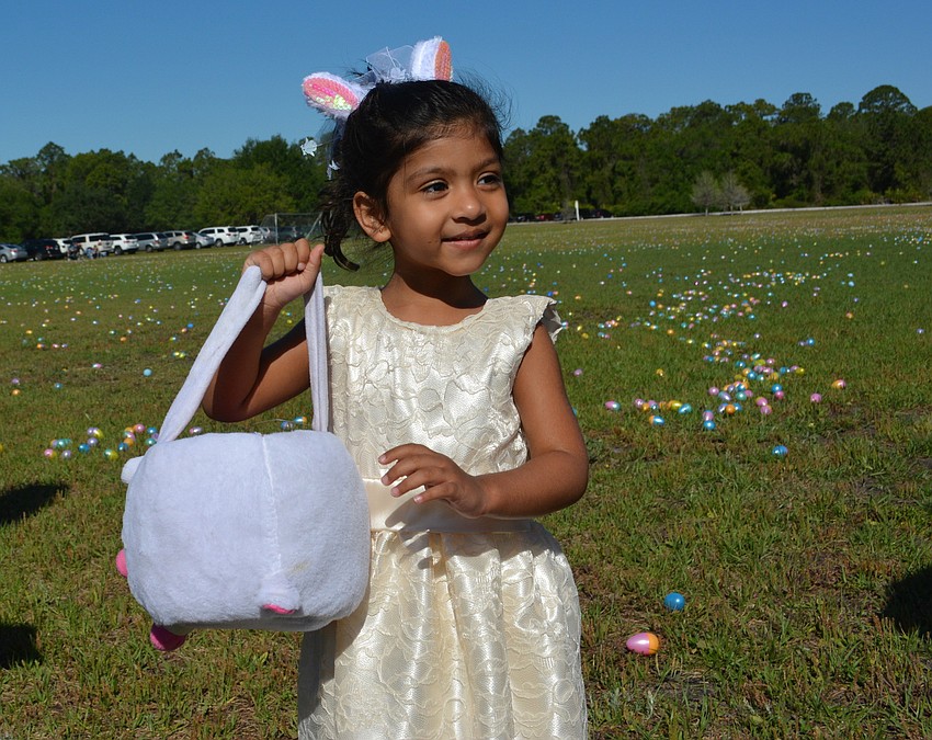 Lakewood Ranch' s Aaliya Mittal, 3, goes after eggs in her best dress.