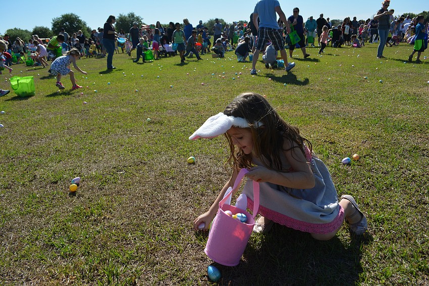 Lakewood Ranch' s Jordan Hanright, 6, grabs as many eggs as she can.