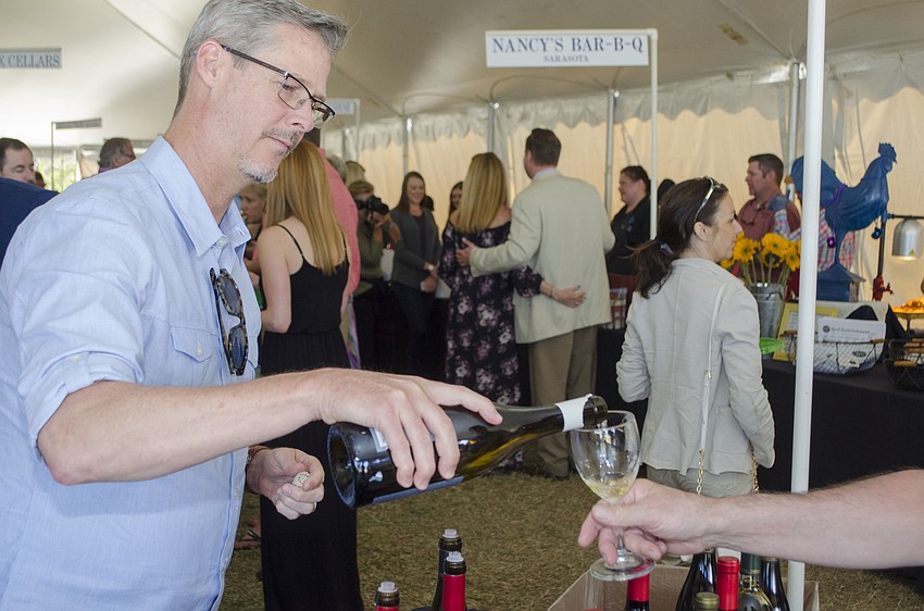 Patrick Madden of Hope Family Wines pours a taste of the winery’s Treana Chardonnay at the Florida Winefest & Auction Grand Tasting, Brunch and Charity Auction on April 8 on the grounds of the Van Wezel Performing Arts Hall.