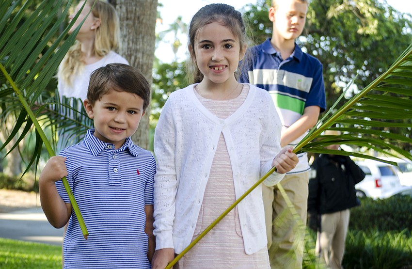 Ascher Latta and Sarah Shea Latta pose with their palms before the Palm Sunday processional at Church of the Redeemer.