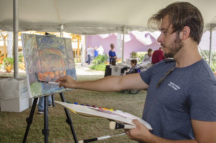 Ringling College of Art and Design student Mirald Cake does a live painting at Wine on the Water on April 9 on the grounds of Van Wezel Performing Arts Hall.