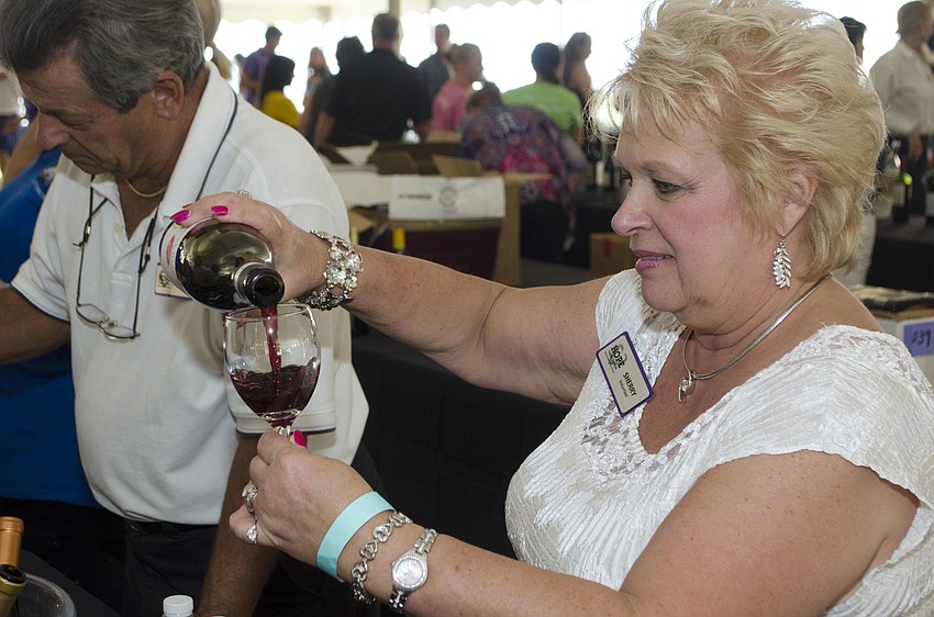 Sherry Cehonski pours a glass of Roserock pinot noir at Wine on the Water on April 9 on the grounds of Van Wezel Performing Arts Hall.