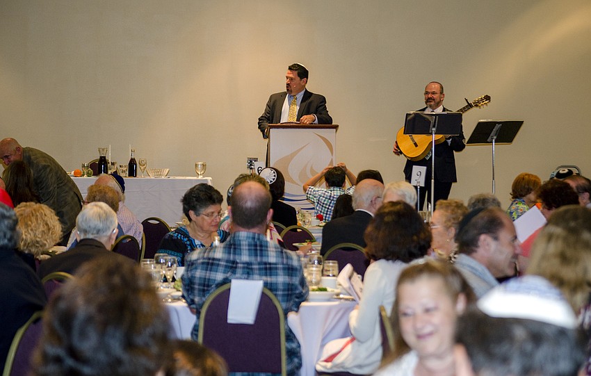 Temple Sinai Rabbi Michael Churgel leads Temple Sinai in its community Seder.