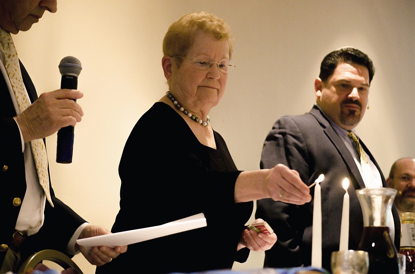 Doris Benice lights the candles at the beginning of the Seder feast.