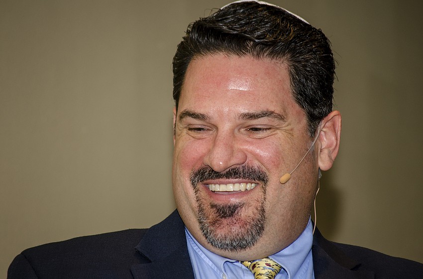 Temple Sinai Rabbi Michael Churgel leads Temple Sinai in its community Seder.