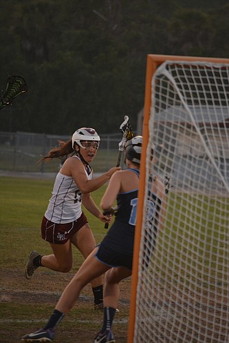 Veronica McCurdy drives the net against The Out-of-Door Academy.