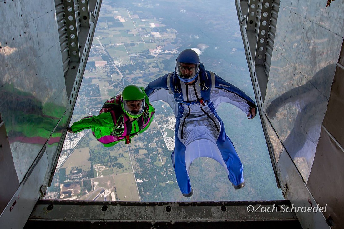 East Countyâ€™s Michelle and Todd Statdfield leap out of an airplane to start a wingsuit jump.