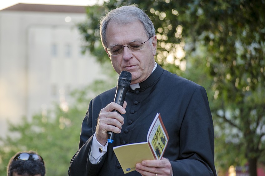 Rev. Fred Robinson from Church of the Redeemer welcomed worshippers to the Good Friday walk down Main Street to recognize the stations of the cross.
