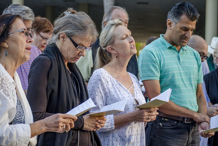 Participants practice the hymns, which were sung between stations.