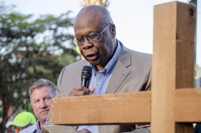 Sarasota Mayor Willie Shaw leads participants through the first stage of the cross at the intersection of Links Avenue and Main Street.
