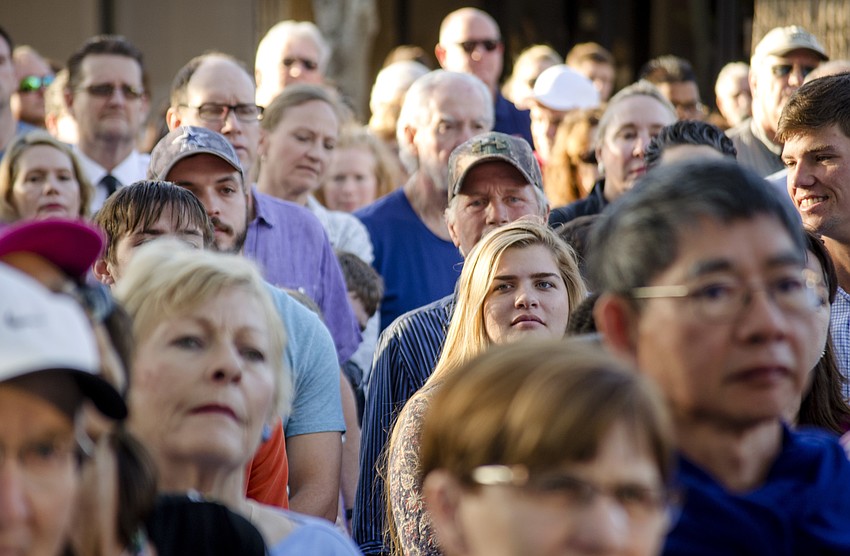 The crowd walked down Main Street toward the Church of the Redeemer.