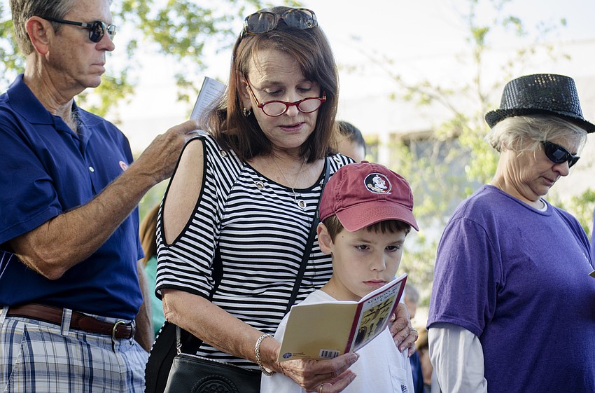 Joyce Long and Roscoe Long follow along as the crowd recognized the sixth station of the cross.