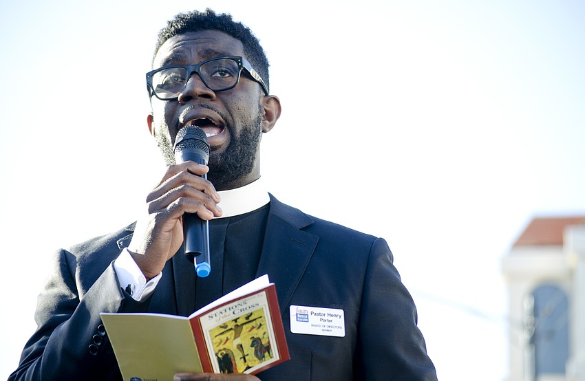 Rev. Henry Porter leads the crowd through the 11th station of the cross in front of First United Methodist Church on Pineapple Avenue.