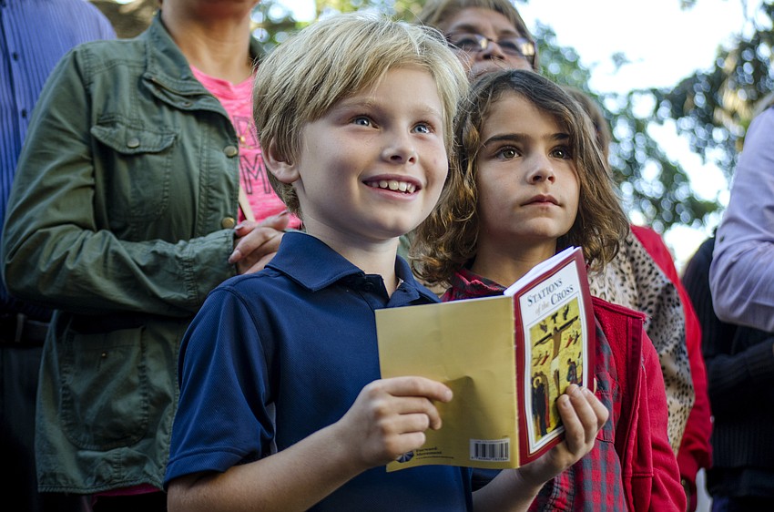 Will Piazzo smiles as Rev. Fred Robinson finishes leading the audience through the 14th and final station of the cross in front of the Church of the Redeemer at 222 S Palm Ave.