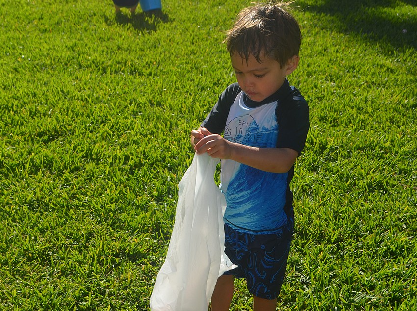 Jack Magboo, 3, collects Easter eggs during Sand Cays’ Easter Egg Hunt.
