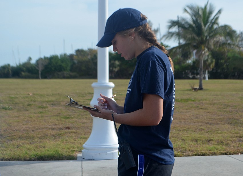 Brooke Picchi writes down the different kinds of trash her group picked up.