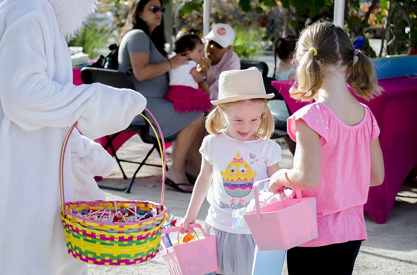 Sami and Alex Brainsfield collect Easter treats from the Easter bunny.