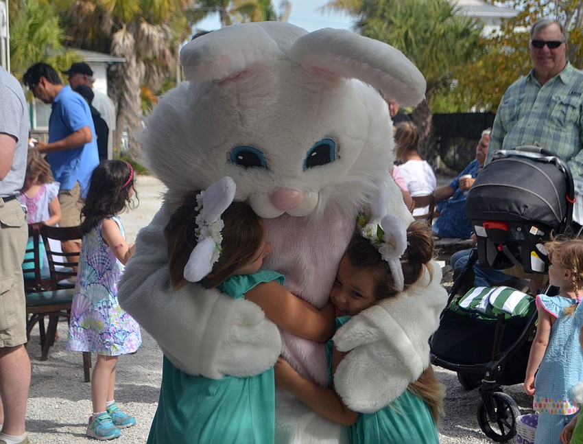 Mila and Mora Muise hug the Easter Bunny at Mar Vista on April 15. They were just two of many kids who searched for 2,300 eggs.
