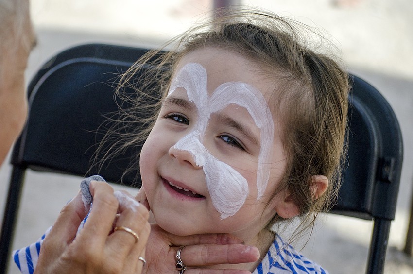 Charlotte Berkowski gets her face painted at the Siesta Key Easter Egg Hunt.