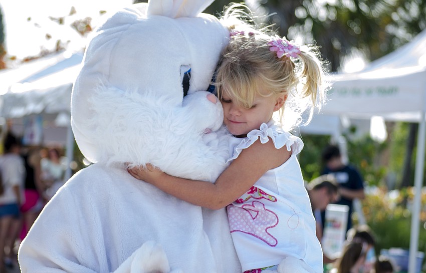 Rachel Wenk hugs the Easter bunny at the Siesta Key Easter Egg hunt.