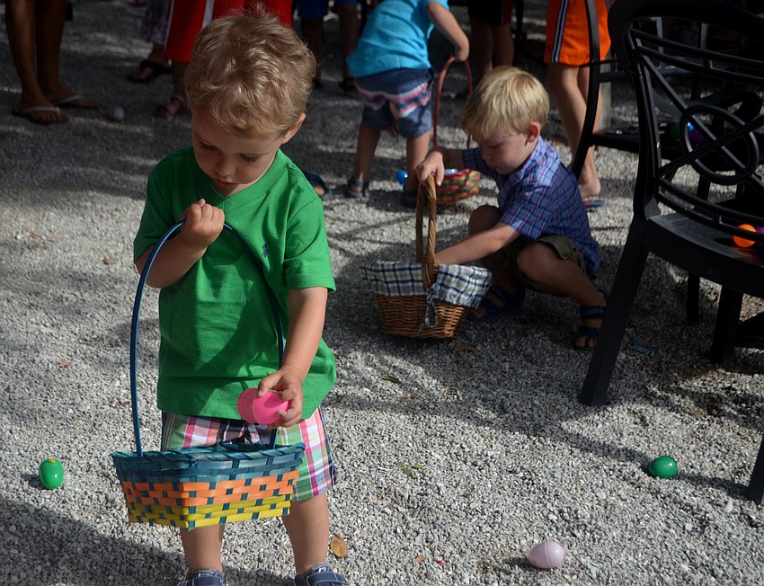 Declan Keller fills his Easter basket with candy and eggs.