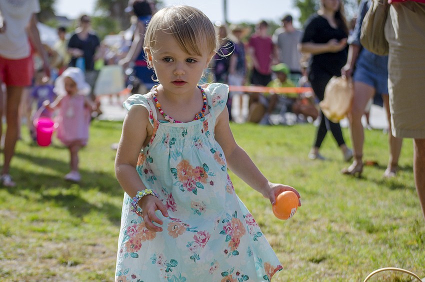Addie Dubois collects eggs during the Siesta Key Easter Egg Hunt.