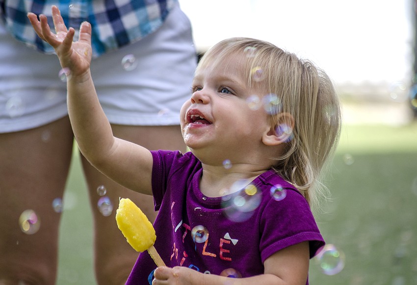 Sophie Leaf tries to catch a bubble after the Southside Easter Egg Hunt.