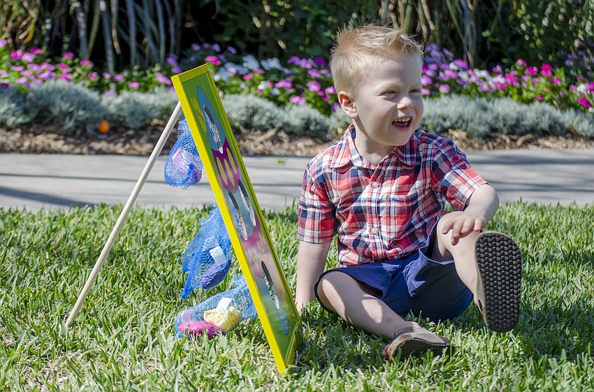 Rhys Fowler plays with the Easter themed bag toss before Selby'  s Easter brunch.
