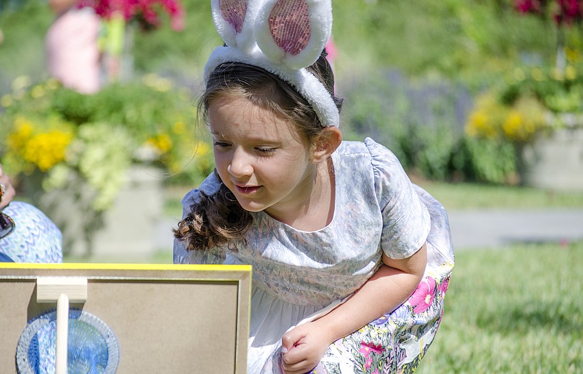 Gianna Velez plays with the Easter themed bag toss before Selby'  s Easter brunch.