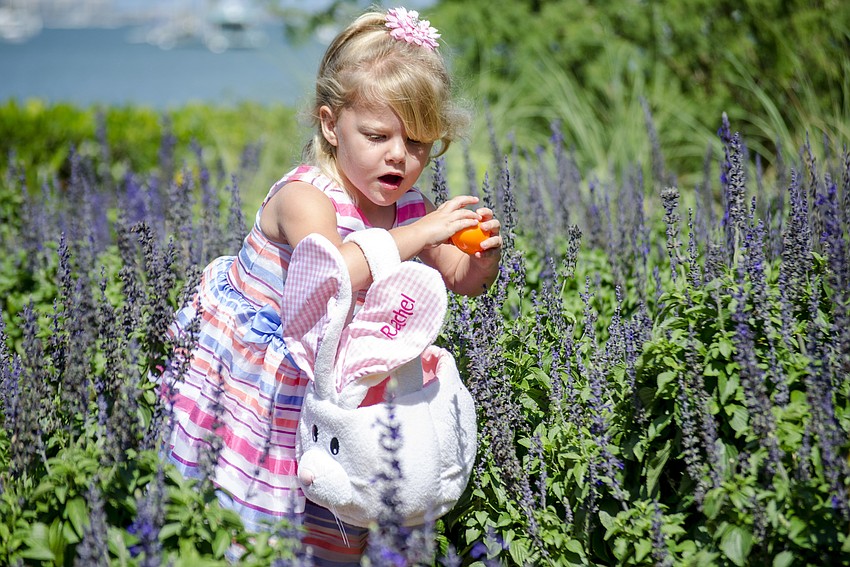 Rachel Wenk collects Easter eggs in the garden.