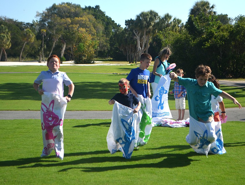 Michael Casingal, Brady Lippert, Toby Hansen and William Flint race each other to the finish line during the Longboat Key Club’s Easter celebration on April 16.