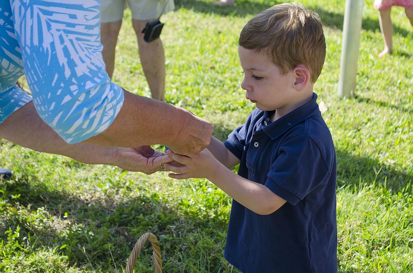 Jack Hetland checks out his candy collection with his grandmother at the Casa Del Mar Beach Resort Easter egg hunt on April 16 at Casa Del Mar.