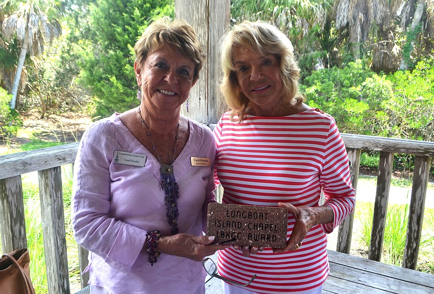 Carol Peschel and Joan Partridge accept the beautification award the Longboat Island Chapel’s Friendship Garden.