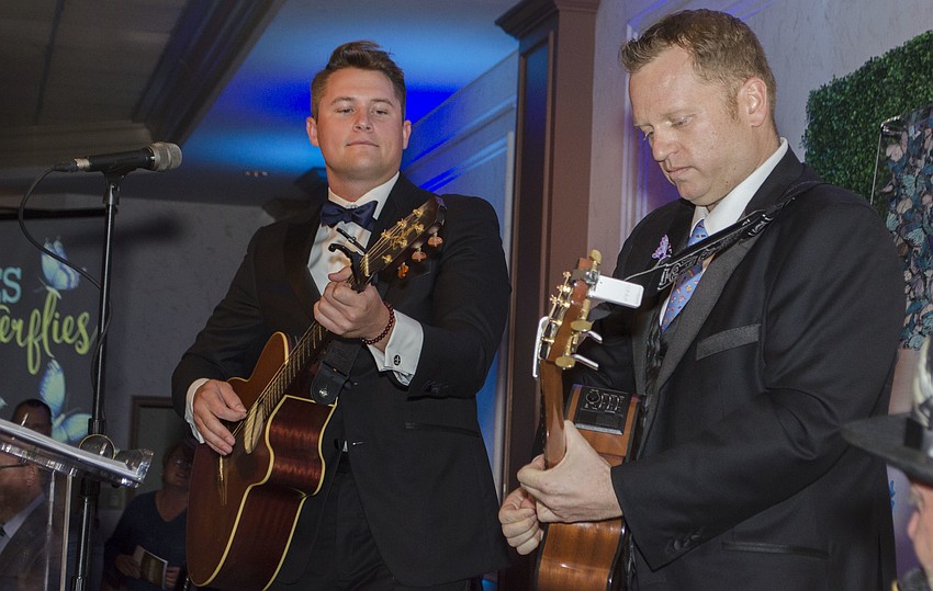 Bart Lowther and Brian Mariash perform an “original” song about Child Protection Center during Blue Ties and Butterflies on April 19 at Michael’s On East.